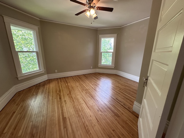 1527 7th St, Peru, IL 61354 - spare room featuring baseboards, light wood finished floors, crown molding, and ceiling fan