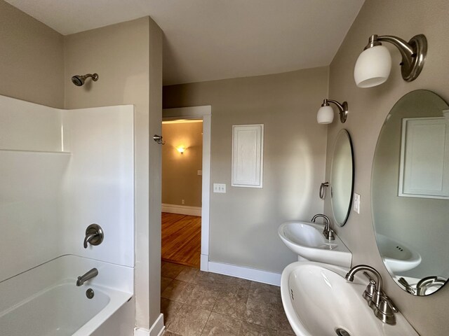 1527 7th St, Peru, IL 61354 - bathroom with a sink,  shower combination, baseboards, and tile patterned flooring