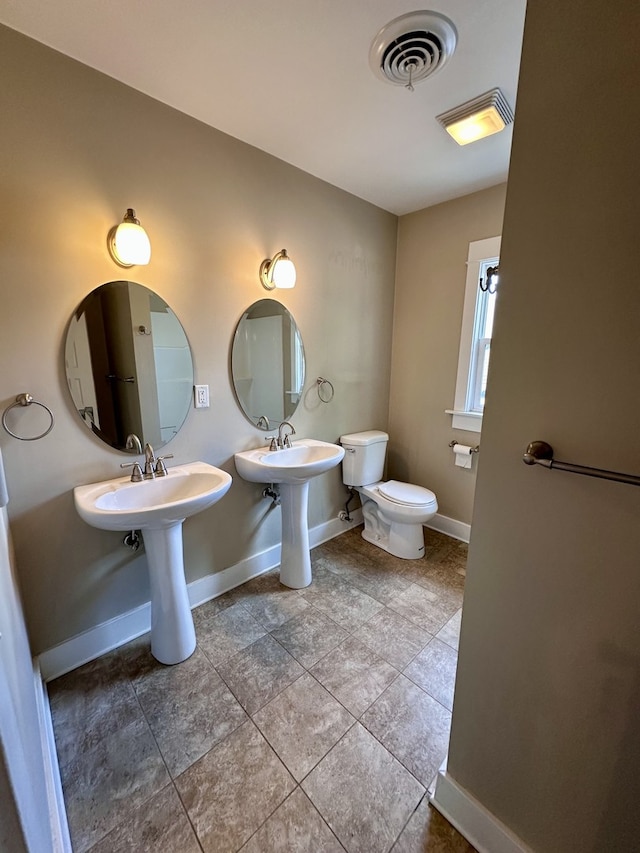 1527 7th St, Peru, IL 61354 - bathroom with toilet, baseboards, and tile patterned flooring