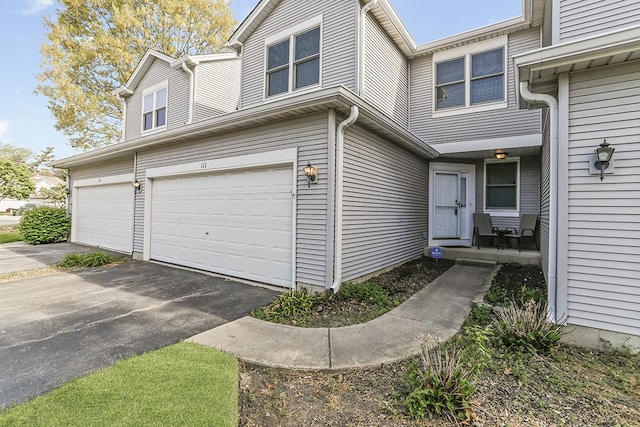 111 Woodland Cir, North Aurora, IL 60542 - view of front of property featuring an attached garage and driveway