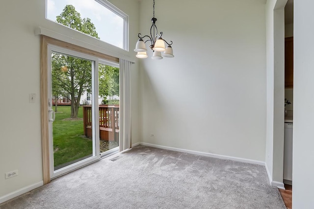 111 Woodland Cir, North Aurora, IL 60542 - unfurnished dining area featuring carpet flooring, a chandelier, baseboards, and arched walkways