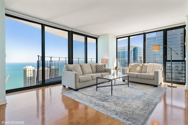 225 N Columbus Dr Unit 6006, Chicago, IL 60601 - living room with a wall of windows, wood finished floors, a water view, and a city view