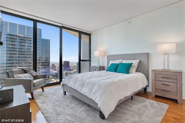 225 N Columbus Dr Unit 6006, Chicago, IL 60601 - bedroom with wood finished floors, a wall of windows, and a view of city
