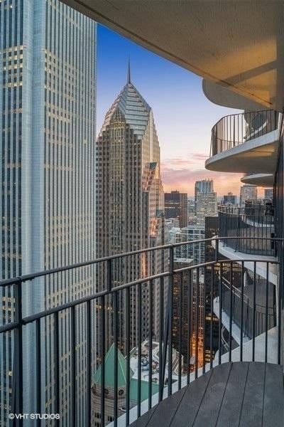 225 N Columbus Dr Unit 6006, Chicago, IL 60601 - balcony at dusk featuring a view of city