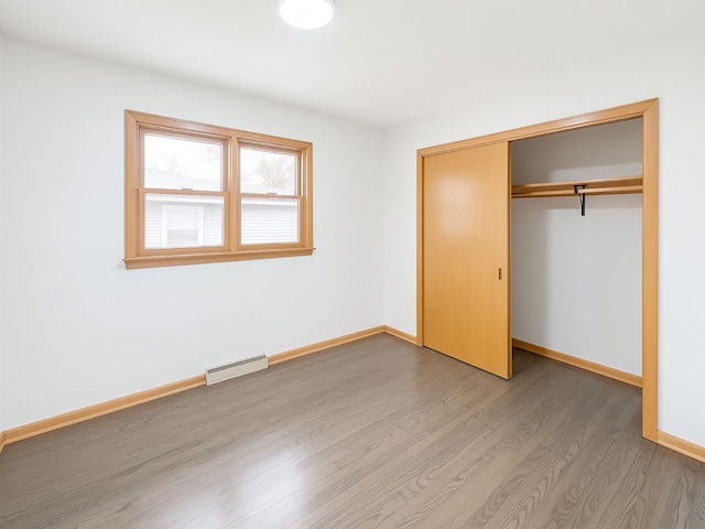 112 Burton Ave, Waukegan, IL 60085 - unfurnished bedroom with wood finished floors, baseboards, and a closet