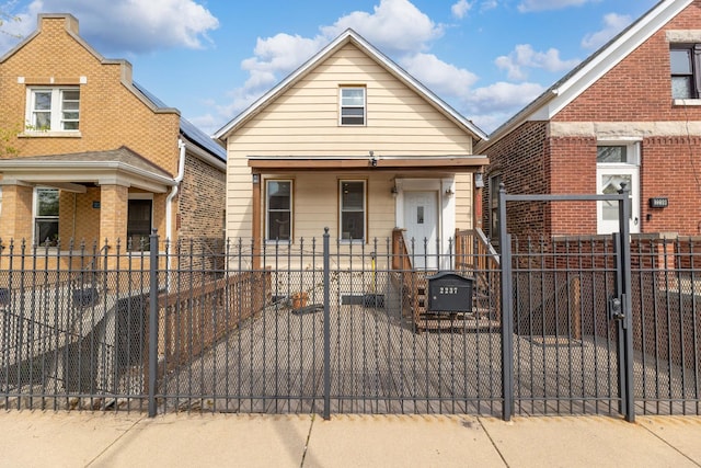 view of front of house with a fenced front yard and a gate