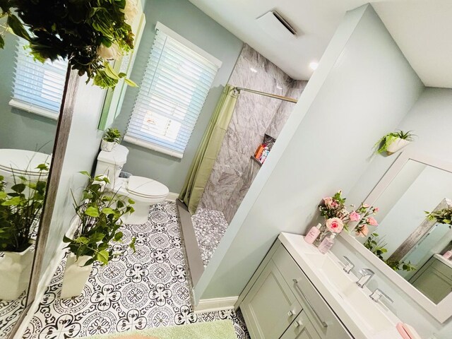 321 Lewis Ave, Wauconda, IL 60084 - bathroom with toilet, tiled shower, baseboards, and tile patterned flooring