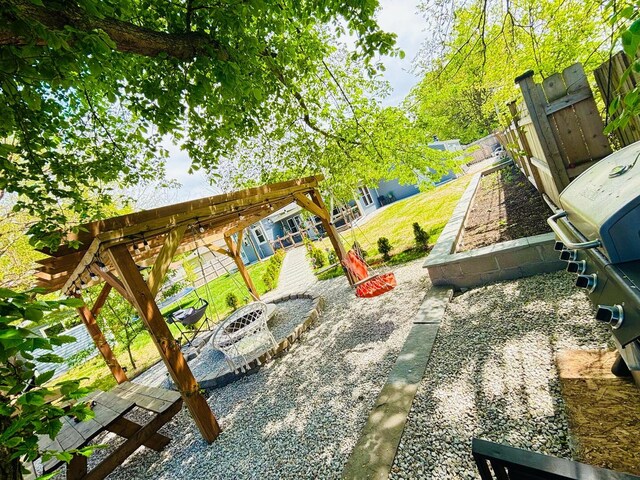 321 Lewis Ave, Wauconda, IL 60084 - view of patio featuring a fenced backyard and a fire pit