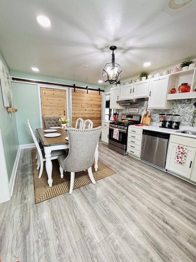 321 Lewis Ave, Wauconda, IL 60084 - dining room with a barn door, light wood-type flooring, recessed lighting, baseboards, and a chandelier