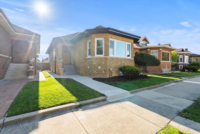 8241 S Aberdeen St, Chicago, IL 60620 - bungalow-style house featuring brick siding and a front lawn
