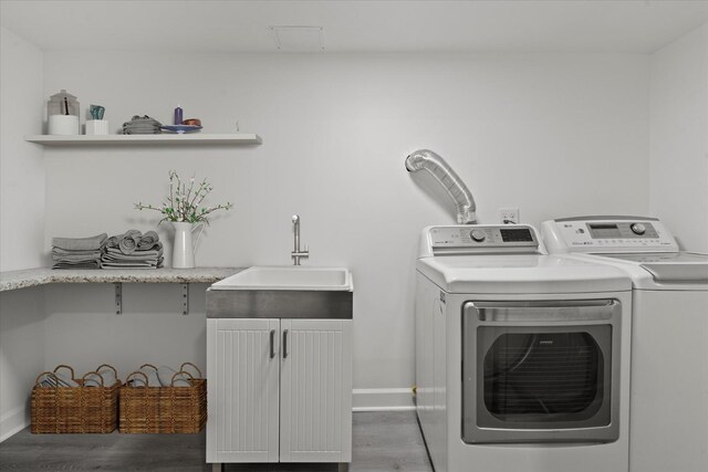 8241 S Aberdeen St, Chicago, IL 60620 - laundry area with washing machine and dryer, wood finished floors, and baseboards