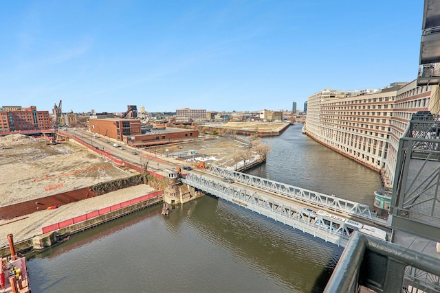 view of urban area with a nearby body of water and a notable bridge