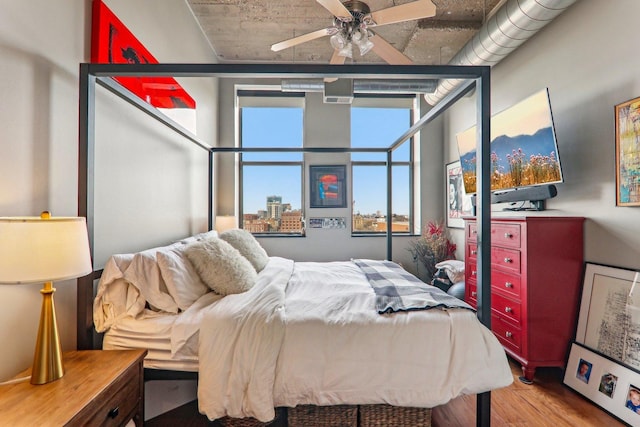 bedroom with light wood finished floors and a ceiling fan