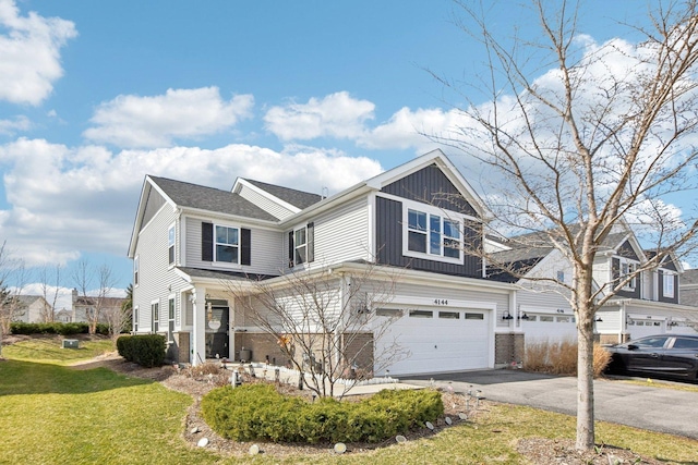 4144 Calder Ln, Aurora, IL 60504 - view of front of house featuring asphalt driveway, a garage, a front yard, board and batten siding, and brick siding