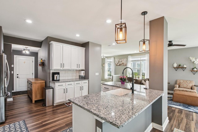4144 Calder Ln, Aurora, IL 60504 - kitchen featuring open floor plan, a sink, dark wood-style flooring, white cabinetry, and recessed lighting