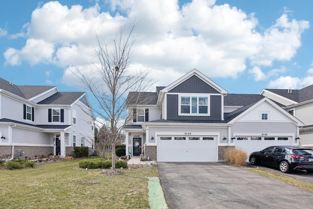 4144 Calder Ln, Aurora, IL 60504 - view of front of property with asphalt driveway, a front lawn, board and batten siding, a garage, and brick siding