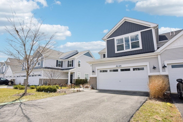 4144 Calder Ln, Aurora, IL 60504 - view of front of home with board and batten siding, driveway, an attached garage, and a residential view