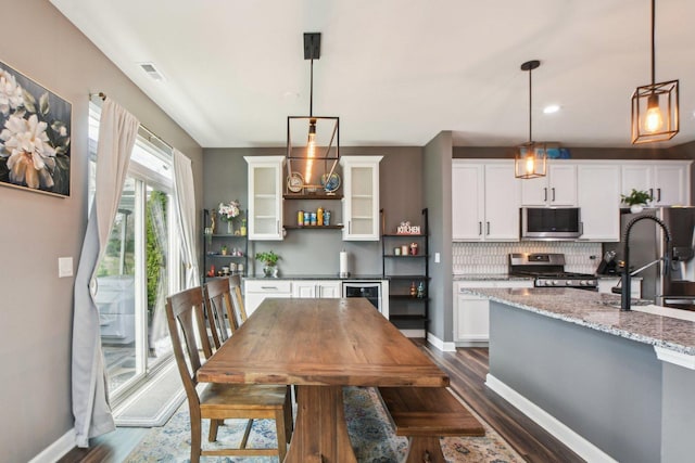 4144 Calder Ln, Aurora, IL 60504 - dining room featuring dark wood-style floors, wine cooler, and baseboards