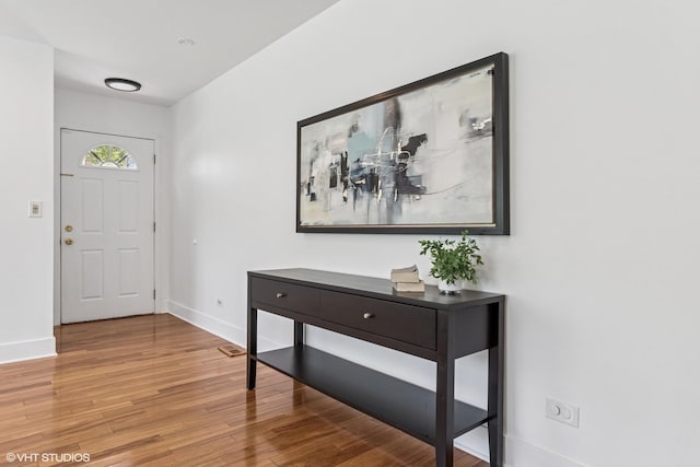 foyer featuring light wood-type flooring and baseboards