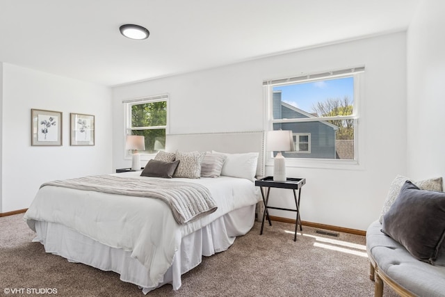 carpeted bedroom featuring baseboards