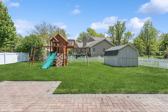 view of play area with a storage unit and an outbuilding