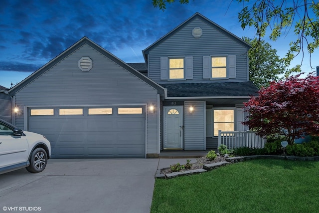 traditional-style home with a porch, concrete driveway, a shingled roof, an attached garage, and a front yard