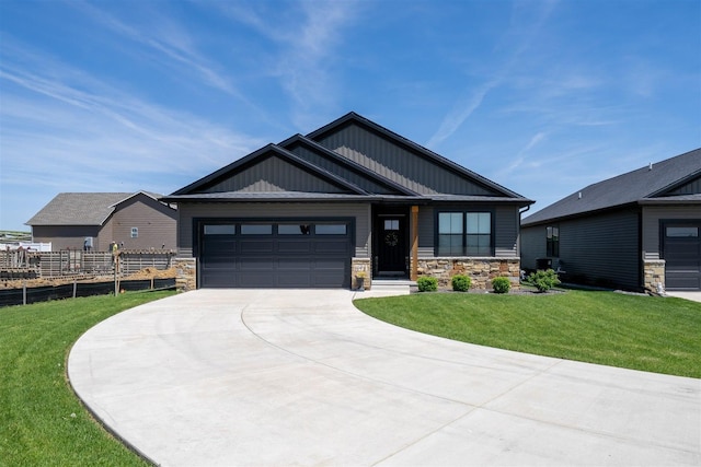 1172 Hershey Rd, Normal, IL 61761 - craftsman-style home featuring stone siding, driveway, an attached garage, and board and batten siding