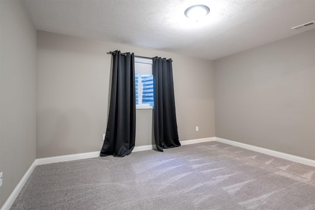 1172 Hershey Rd, Normal, IL 61761 - spare room with carpet flooring, baseboards, and a textured ceiling