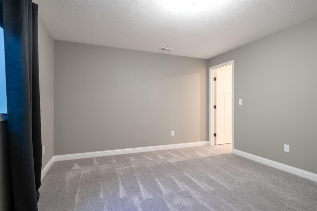 1172 Hershey Rd, Normal, IL 61761 - carpeted spare room with a textured ceiling and baseboards