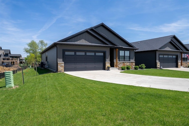 1172 Hershey Rd, Normal, IL 61761 - view of front of home with driveway, stone siding, board and batten siding, and an attached garage