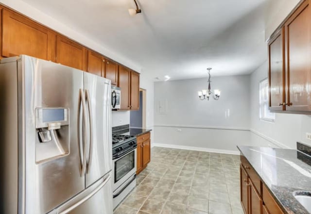 1711 W Estes Ave Unit 2N, Chicago, IL 60626 - kitchen featuring stainless steel appliances, brown cabinets, a chandelier, and dark stone countertops