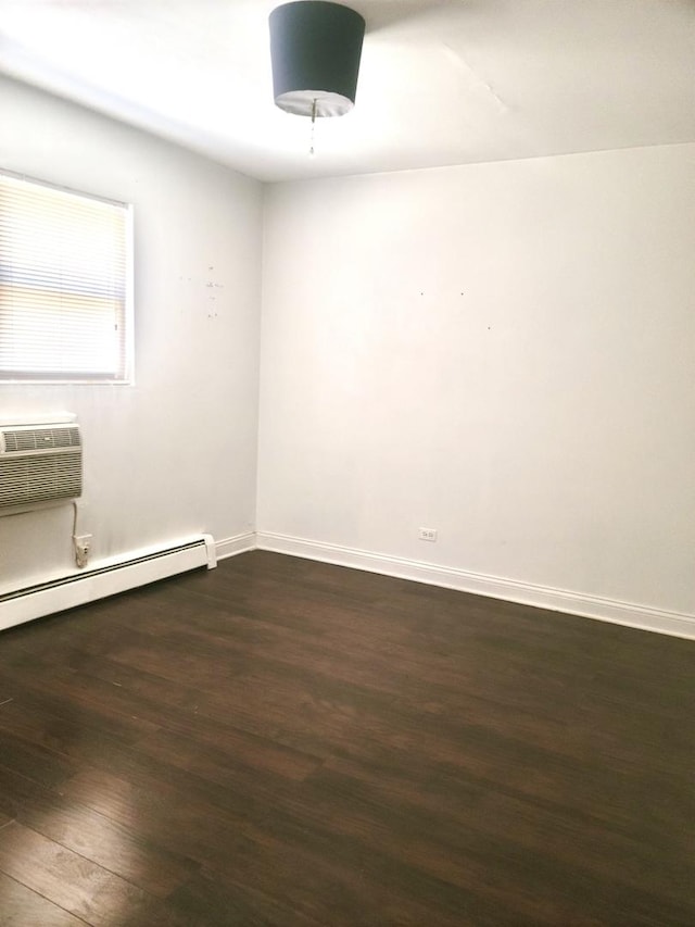 1711 W Estes Ave Unit 2N, Chicago, IL 60626 - empty room with dark wood-type flooring, a wall mounted air conditioner, baseboards, and a baseboard heating unit