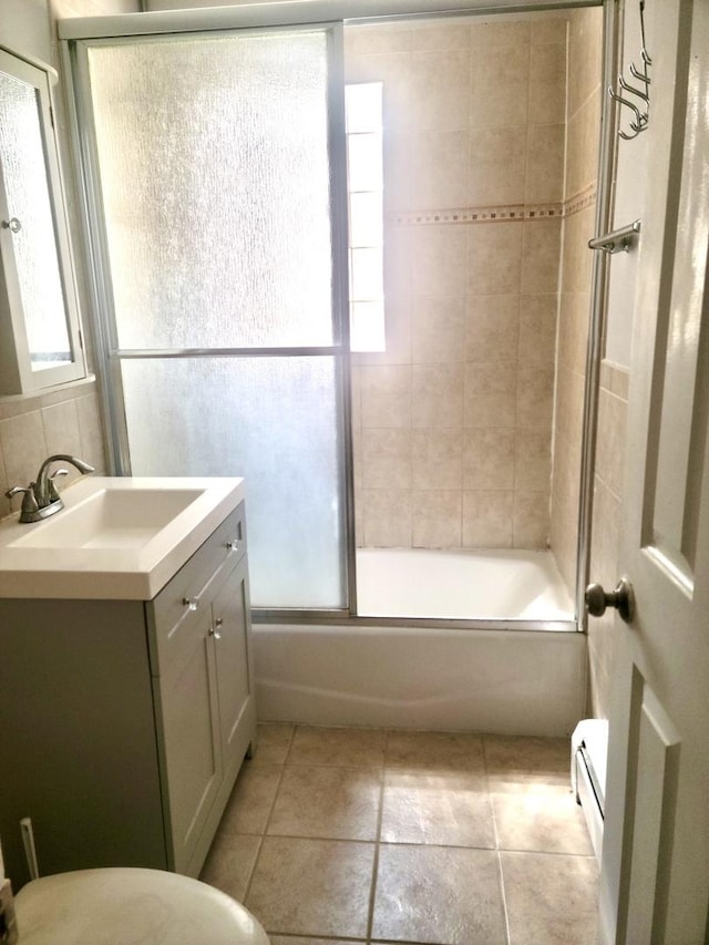 1711 W Estes Ave Unit 2N, Chicago, IL 60626 - bathroom with vanity, tile patterned flooring, bath / shower combo with glass door, a baseboard radiator, and toilet