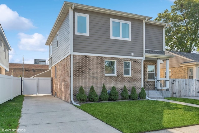 7337 N Mcvicker Ave, Chicago, IL 60646 - view of front of property featuring brick siding, driveway, and a gate