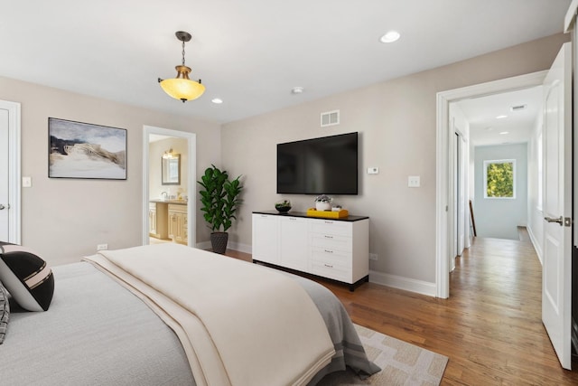 7337 N Mcvicker Ave, Chicago, IL 60646 - bedroom with light wood finished floors, recessed lighting, baseboards, and ensuite bathroom