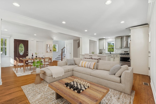 7337 N Mcvicker Ave, Chicago, IL 60646 - living room featuring stairway, recessed lighting, light wood-type flooring, and crown molding