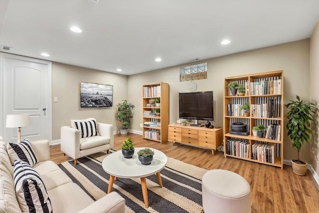 7337 N Mcvicker Ave, Chicago, IL 60646 - living room with wood finished floors, baseboards, and recessed lighting