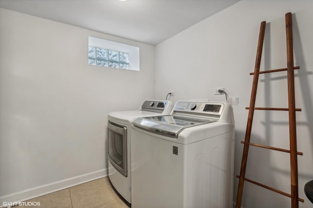 7337 N Mcvicker Ave, Chicago, IL 60646 - washroom with washing machine and clothes dryer, light tile patterned floors, and baseboards
