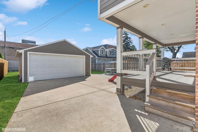 7337 N Mcvicker Ave, Chicago, IL 60646 - view of patio featuring an outbuilding, fence, a detached garage, and a wooden deck