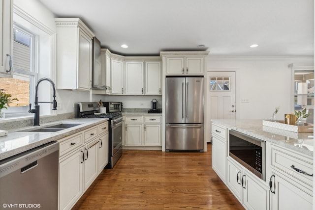 7337 N Mcvicker Ave, Chicago, IL 60646 - kitchen featuring appliances with stainless steel finishes, a sink, light stone counters, wood finished floors, and recessed lighting
