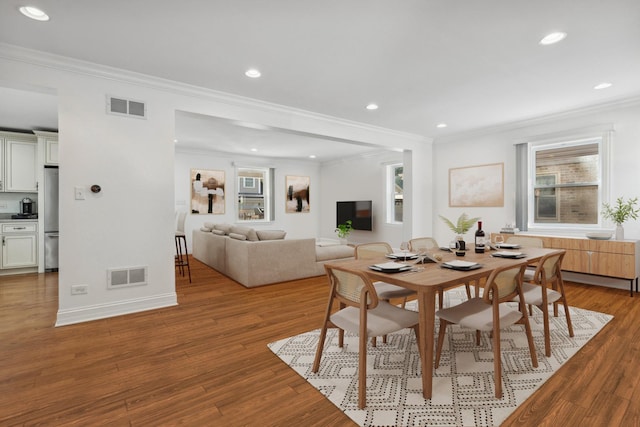 7337 N Mcvicker Ave, Chicago, IL 60646 - dining space featuring crown molding, recessed lighting, light wood finished floors, and baseboards