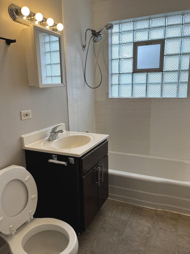 bathroom with toilet,  shower combination, tile patterned floors, and vanity