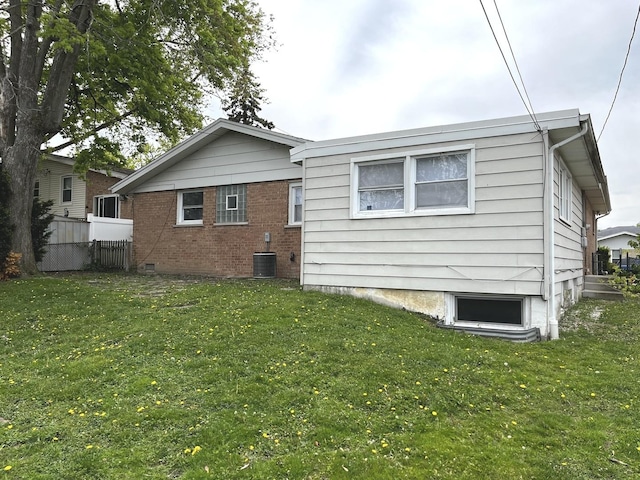 rear view of property featuring central AC unit and brick siding