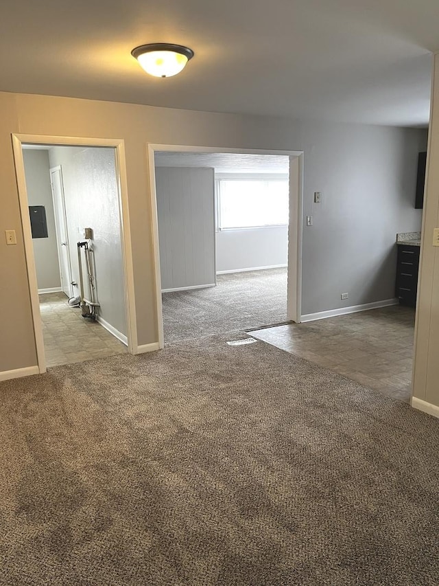 carpeted empty room with baseboards