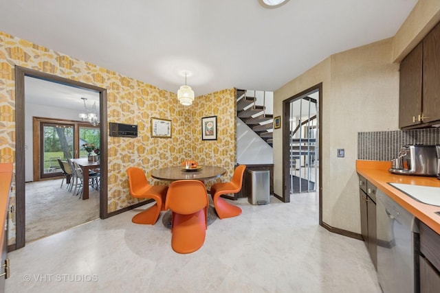 S070 River Ln, Winfield, IL 60190 - dining room with stairs, wallpapered walls, baseboards, and a chandelier