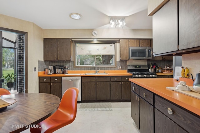 S070 River Ln, Winfield, IL 60190 - kitchen with stainless steel appliances, a sink, decorative backsplash, and light countertops
