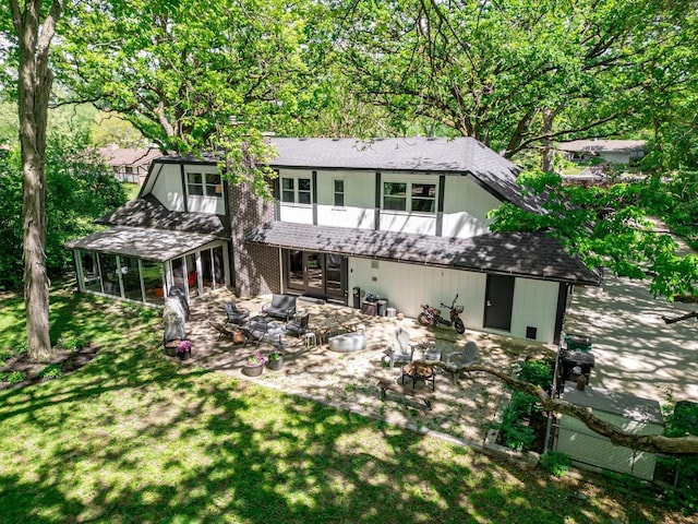 S070 River Ln, Winfield, IL 60190 - back of property with a sunroom, a patio area, a yard, a fire pit, and roof with shingles