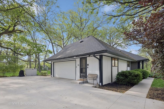 S070 River Ln, Winfield, IL 60190 - view of side of home with a shingled roof, driveway, and an attached garage