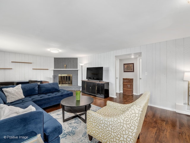 7102 Walden Ln, Darien, IL 60561 - living area featuring dark wood-style flooring, baseboards, a fireplace, and wooden walls