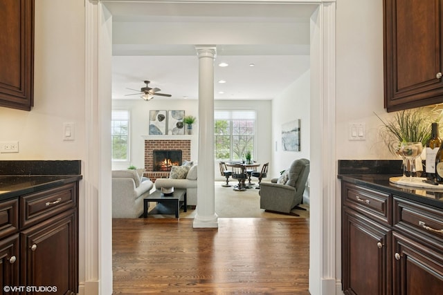 11 Crystal Downs Dr, Hawthorn Woods, IL 60047 - living area with ornate columns, wood finished floors, a ceiling fan, a brick fireplace, and recessed lighting